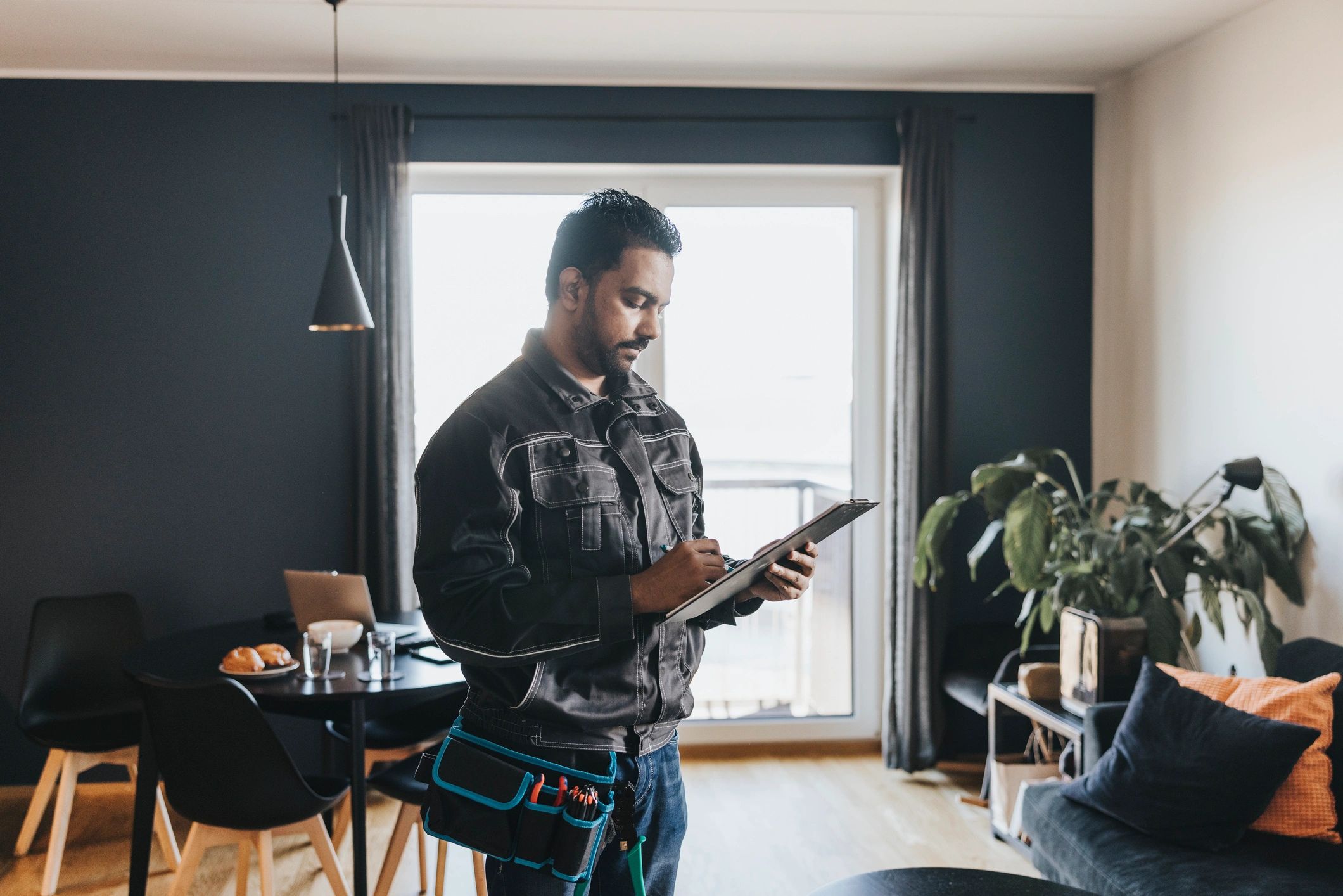Trades technician checking job details on a phone