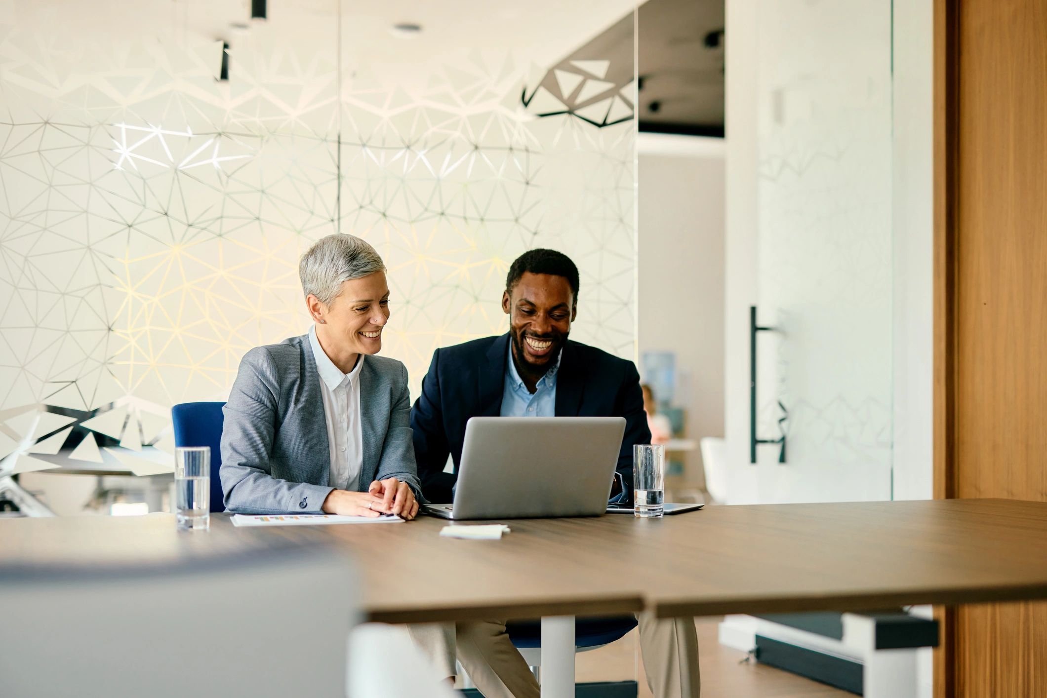 Consultant and business owner reviewing automation ideas on a laptop